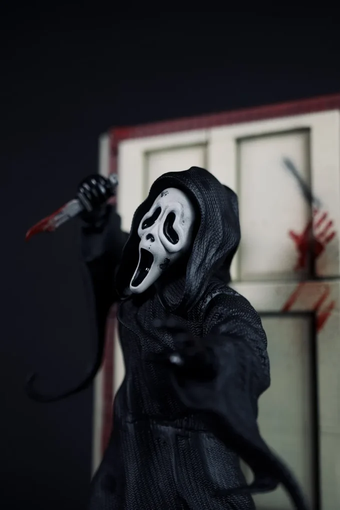 Ghostface figure from Scream with knife, mask, and horror diorama base.