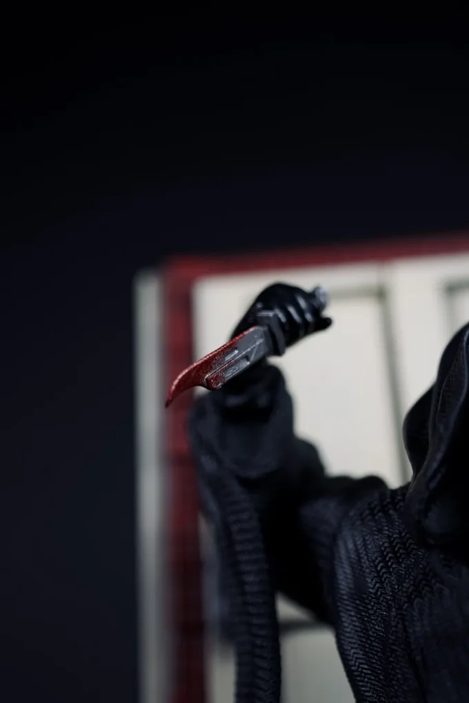 Ghostface figure from Scream with knife, mask, and horror diorama base.