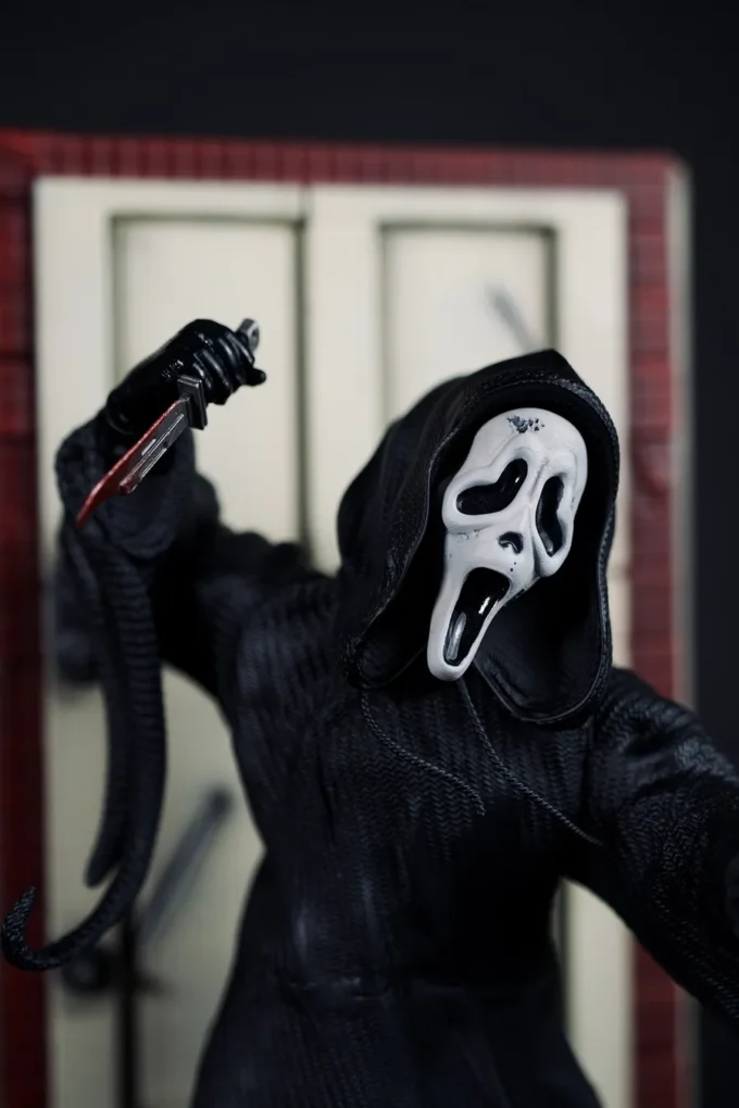 Ghostface figure from Scream with knife, mask, and horror diorama base.